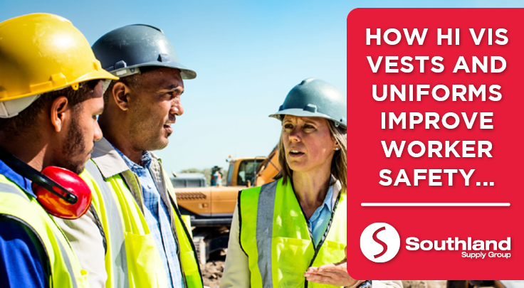 Two men and 1 woman in a construction site wearing hi vis vests and hard hats